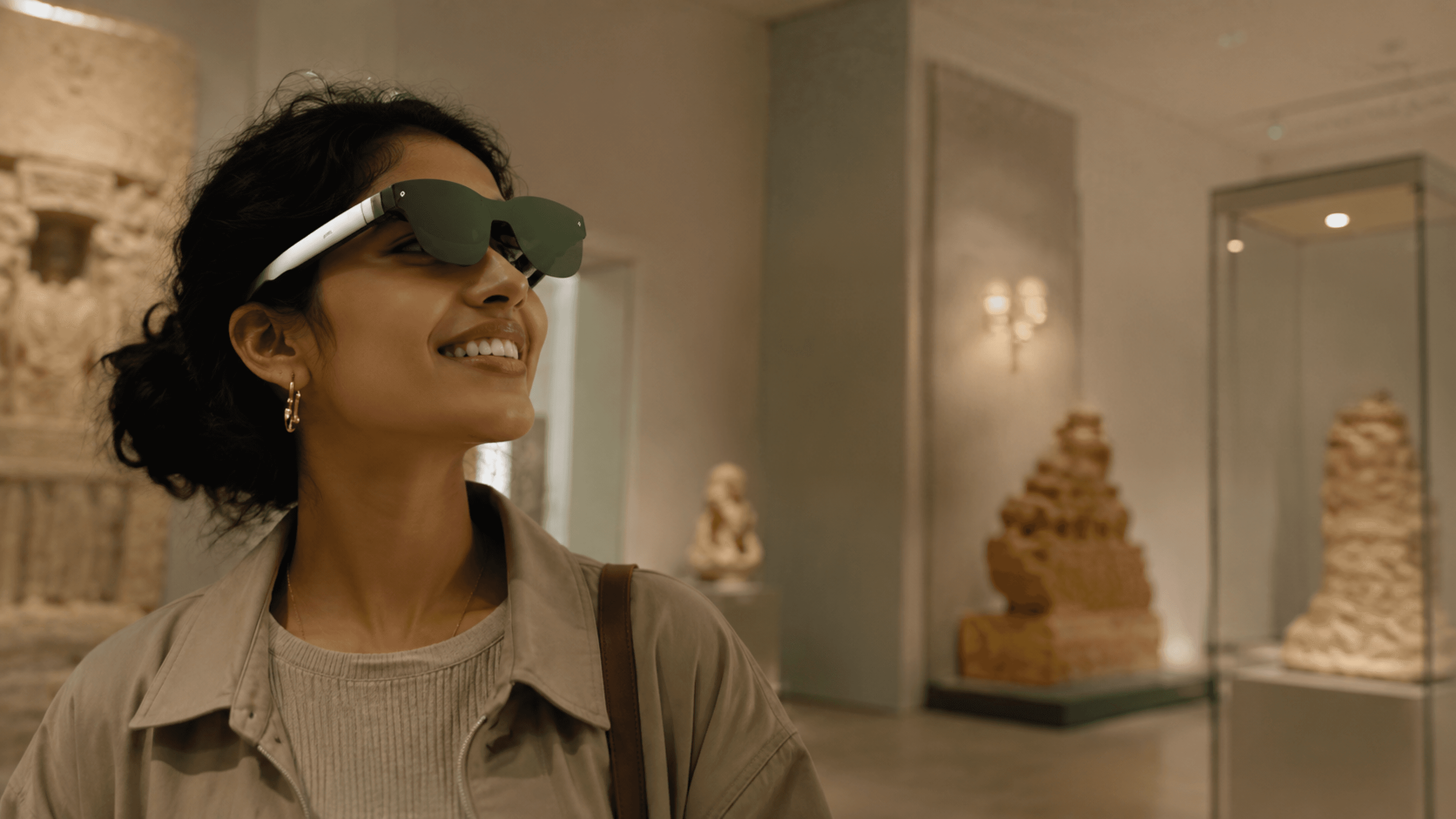 A visitor wearing smart glasses in a gallery, guided by Weave Companion